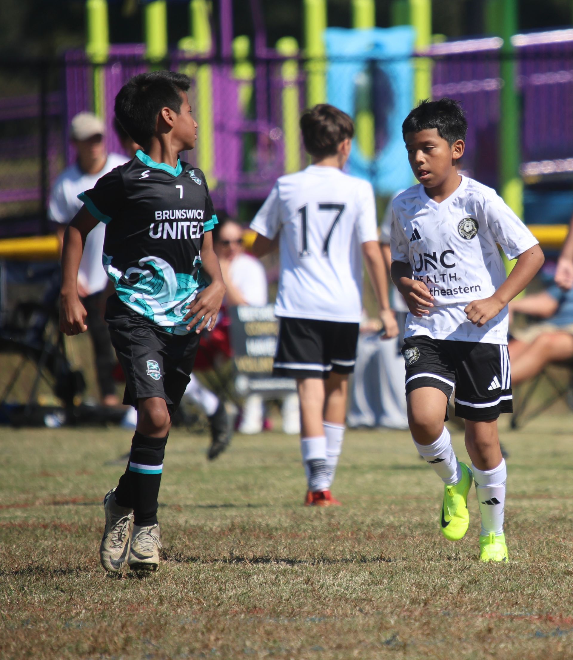 A group of young men are playing soccer on a field