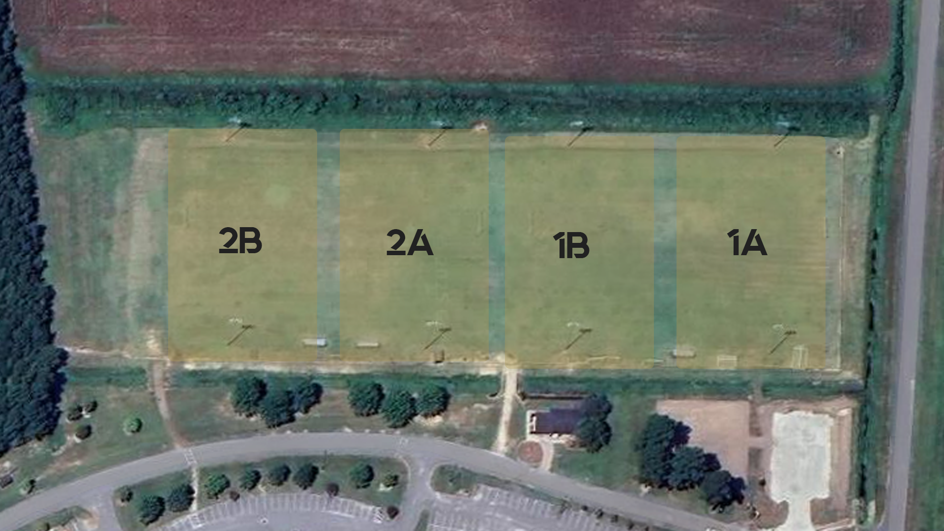 An aerial view of a soccer field with a lot of grass and trees.