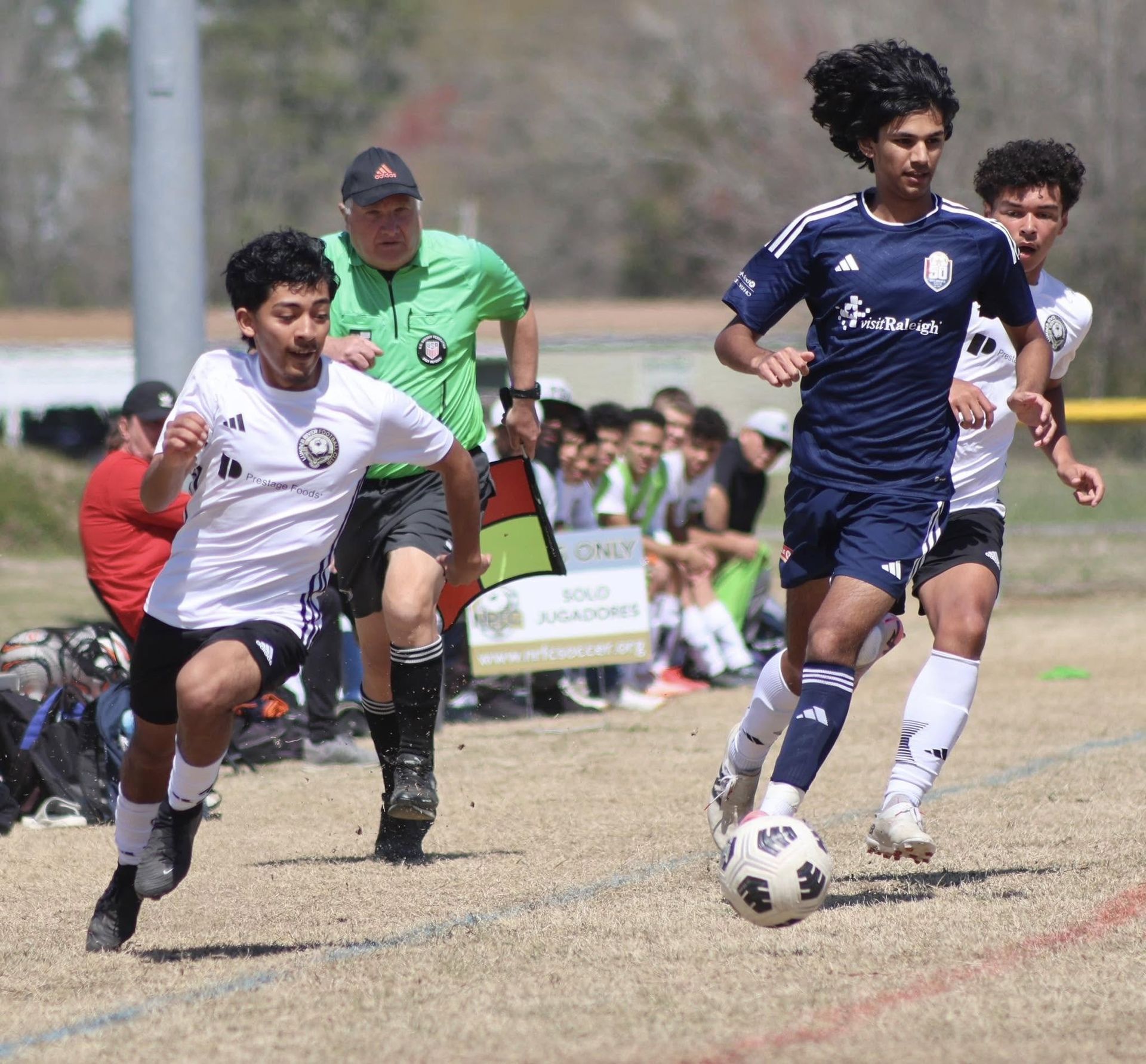 A group of young men are playing soccer on a field