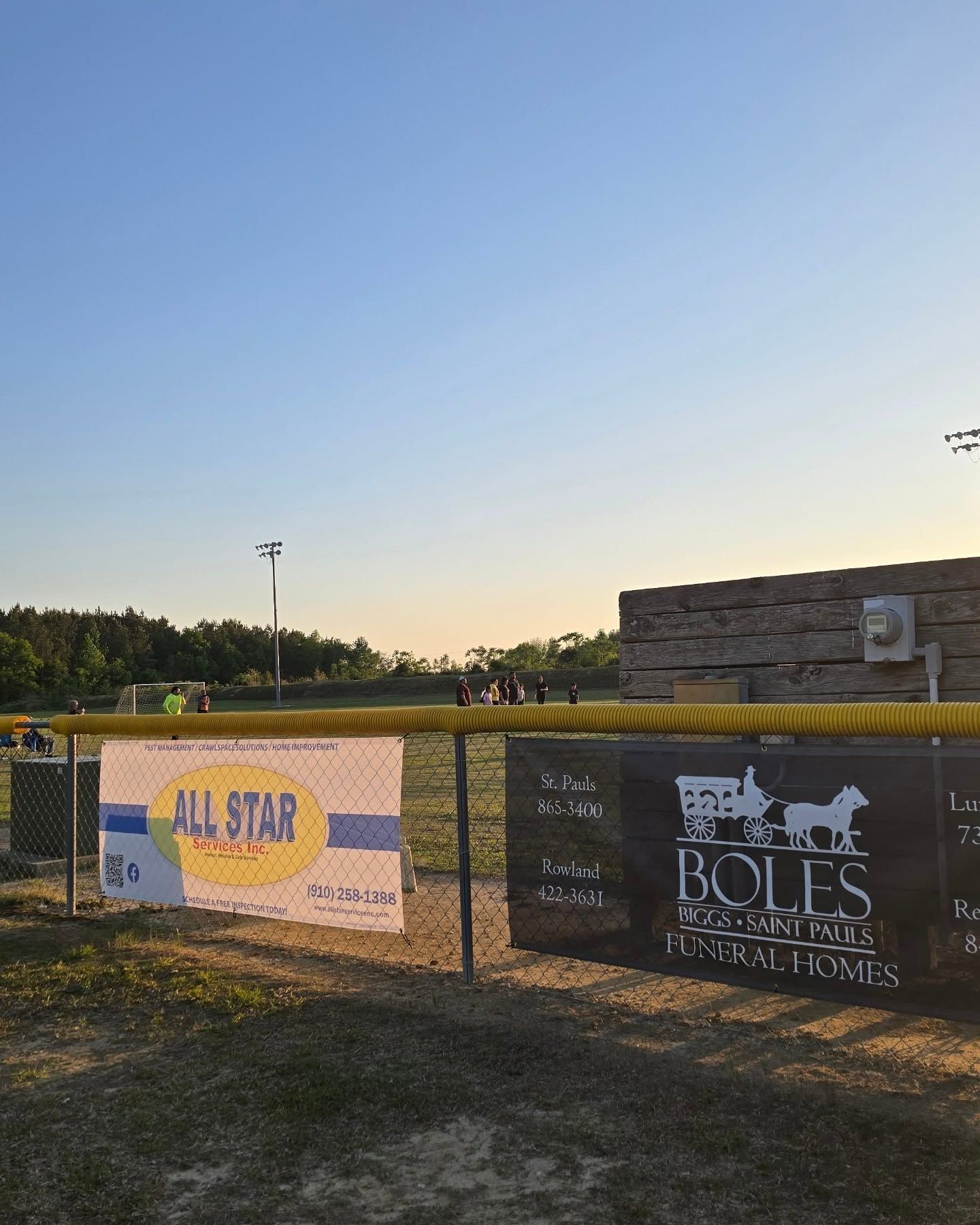 There is a sign that says `` home of robeson county 's premier soccer club ''.