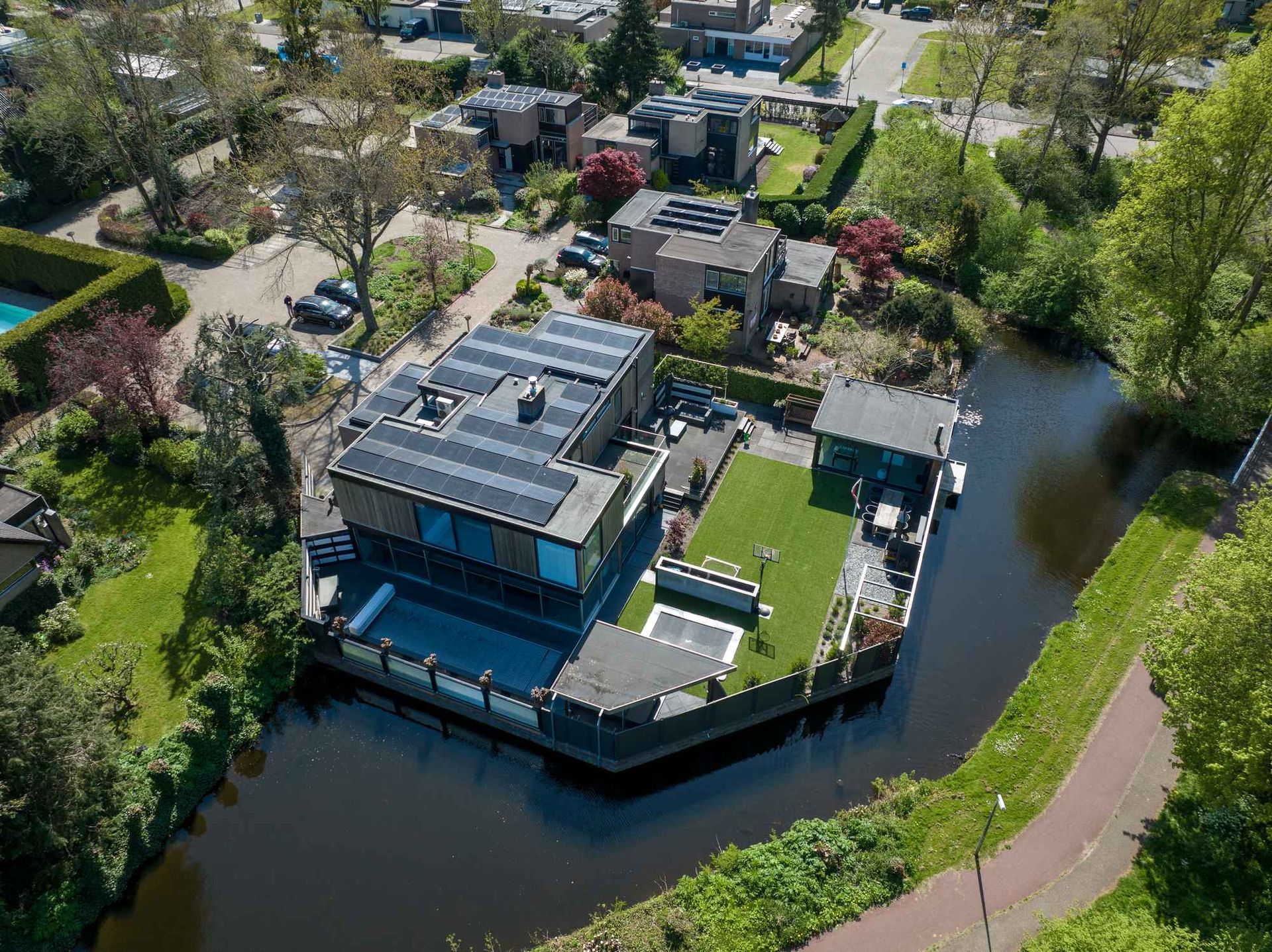 Een luchtfoto van een huis naast een rivier