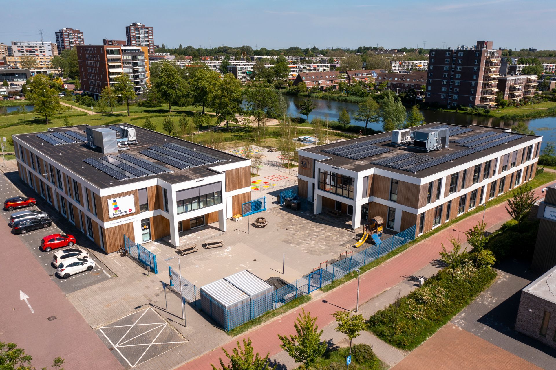 Een luchtfoto van een groot gebouw met zonnepanelen op het dak.