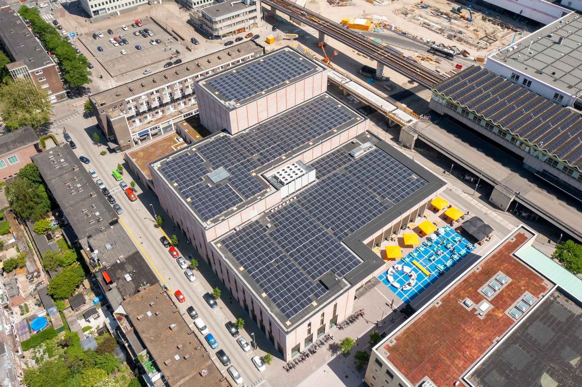Een luchtfoto van een gebouw met zonnepanelen op het dak.