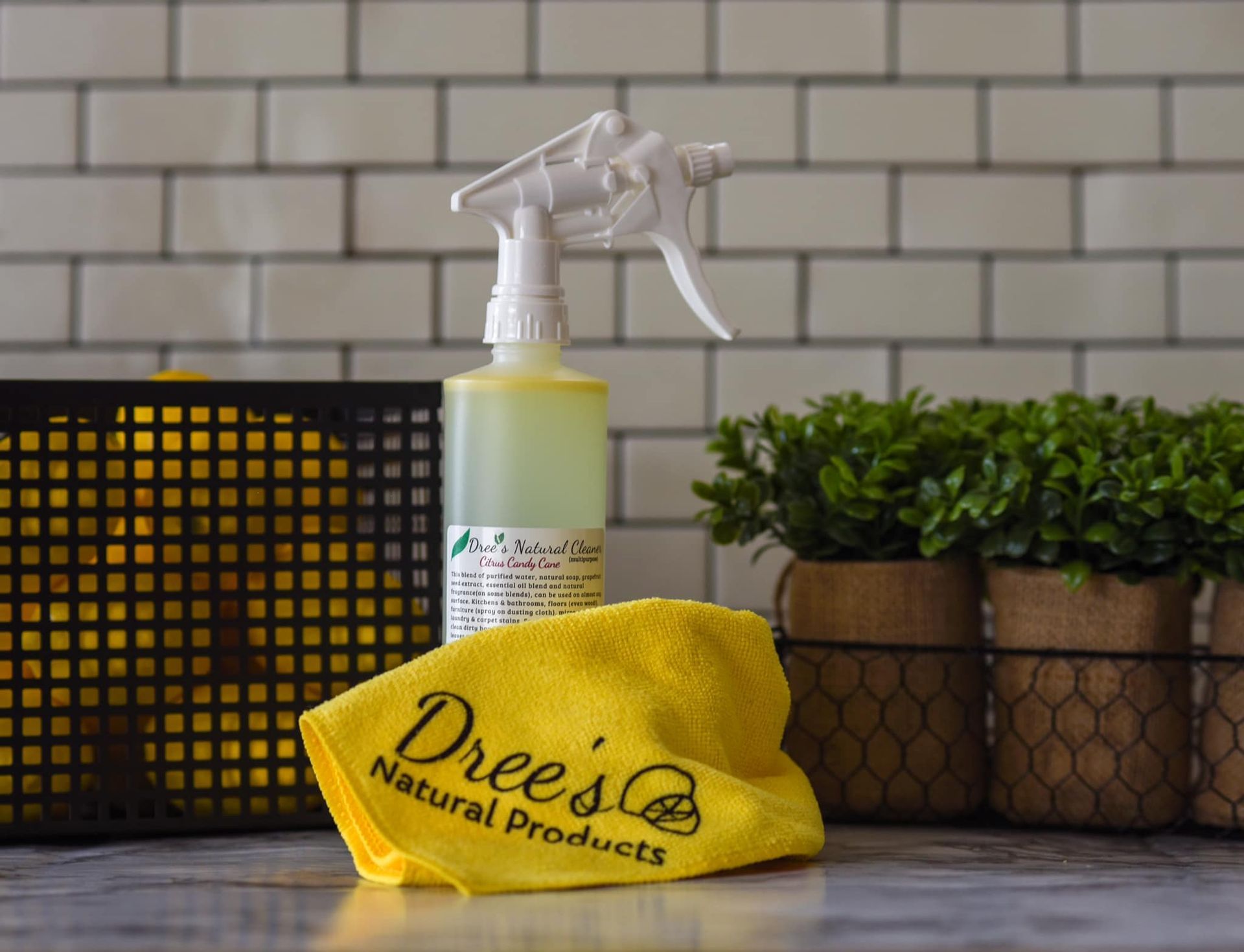 A yellow towel is sitting on a counter next to a spray bottle.
