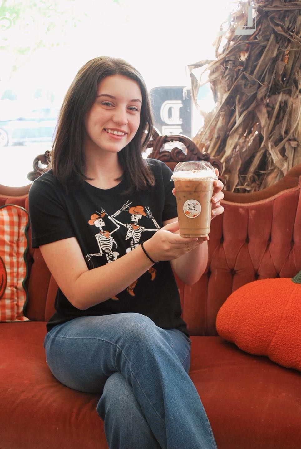 A woman is pouring coffee into a cup in a kitchen.
