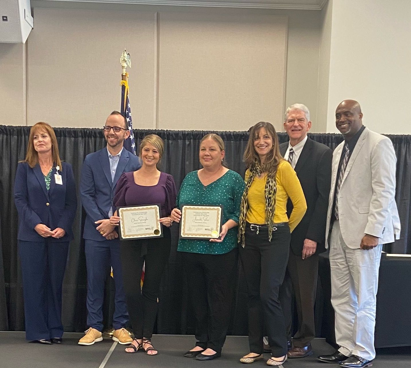 A group of people standing next to each other holding certificates.