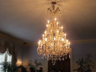 A large chandelier is hanging from the ceiling in a room