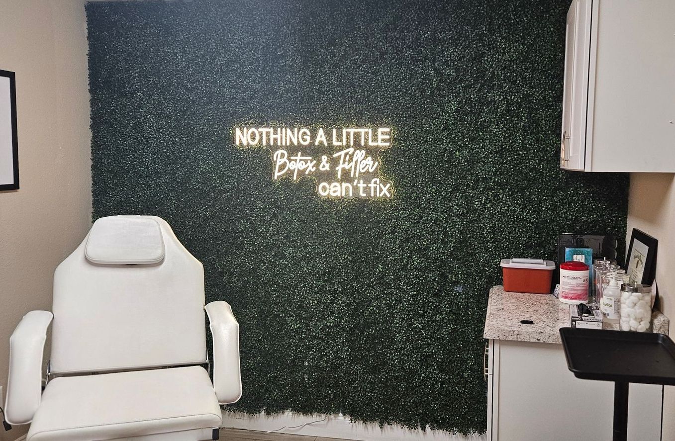 A chair is sitting in front of a wall with a neon sign that says nothing a little