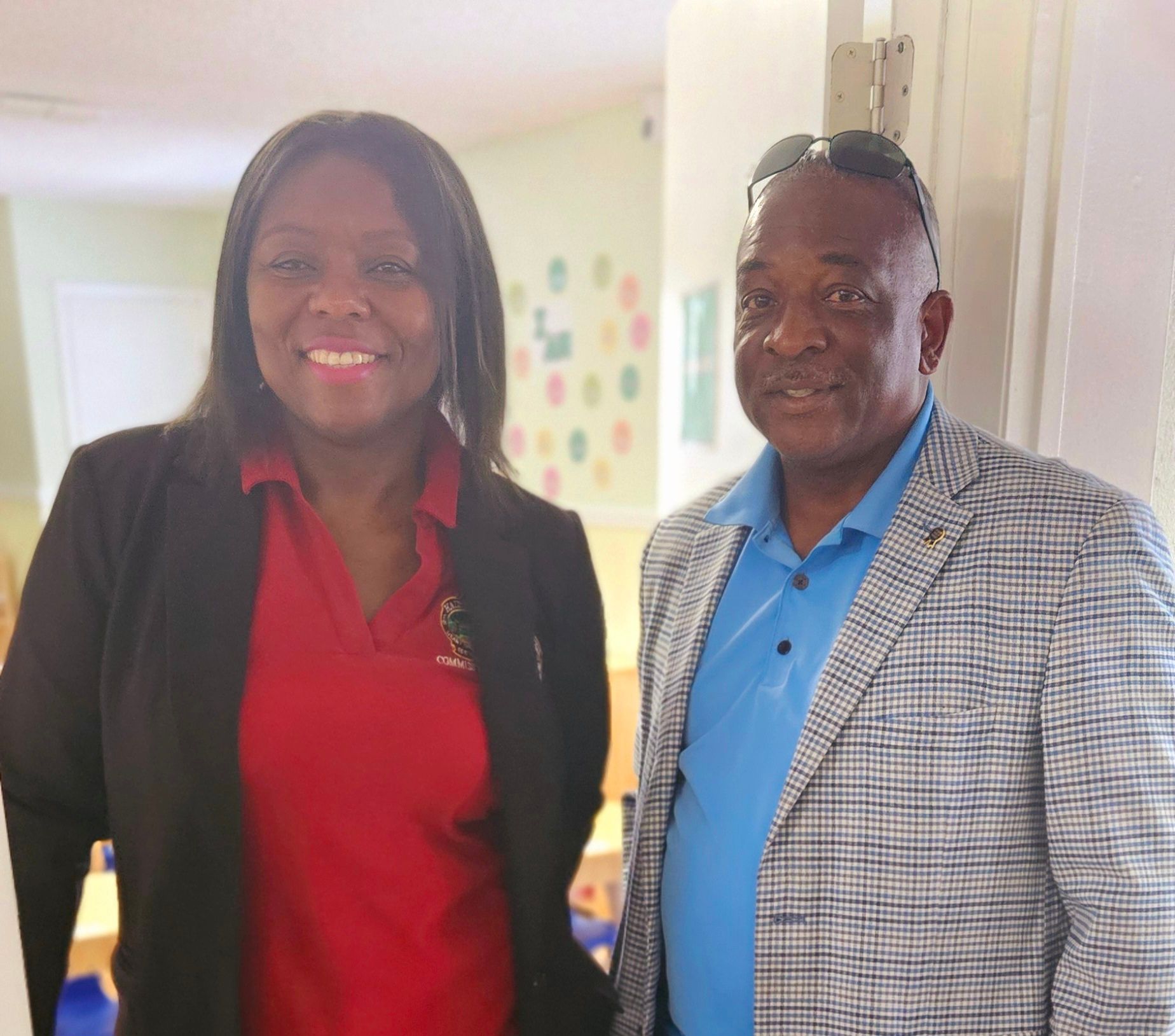 A man and a woman are standing next to each other and smiling