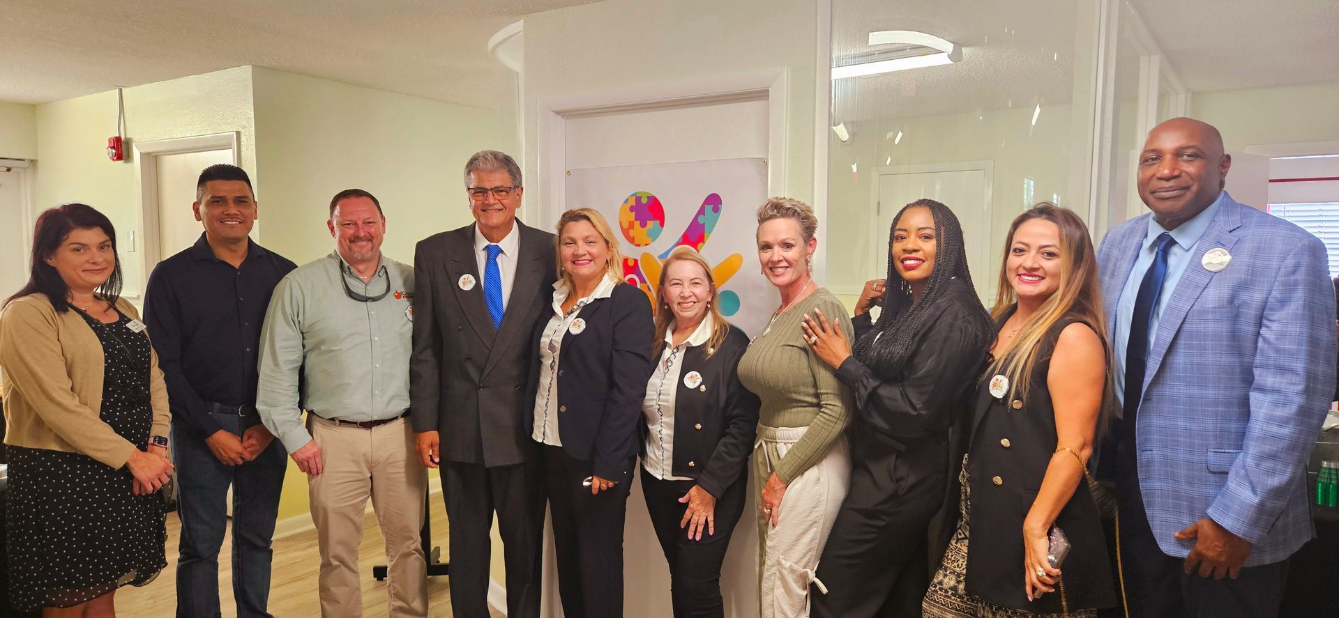 A group of people are posing for a picture in a room.