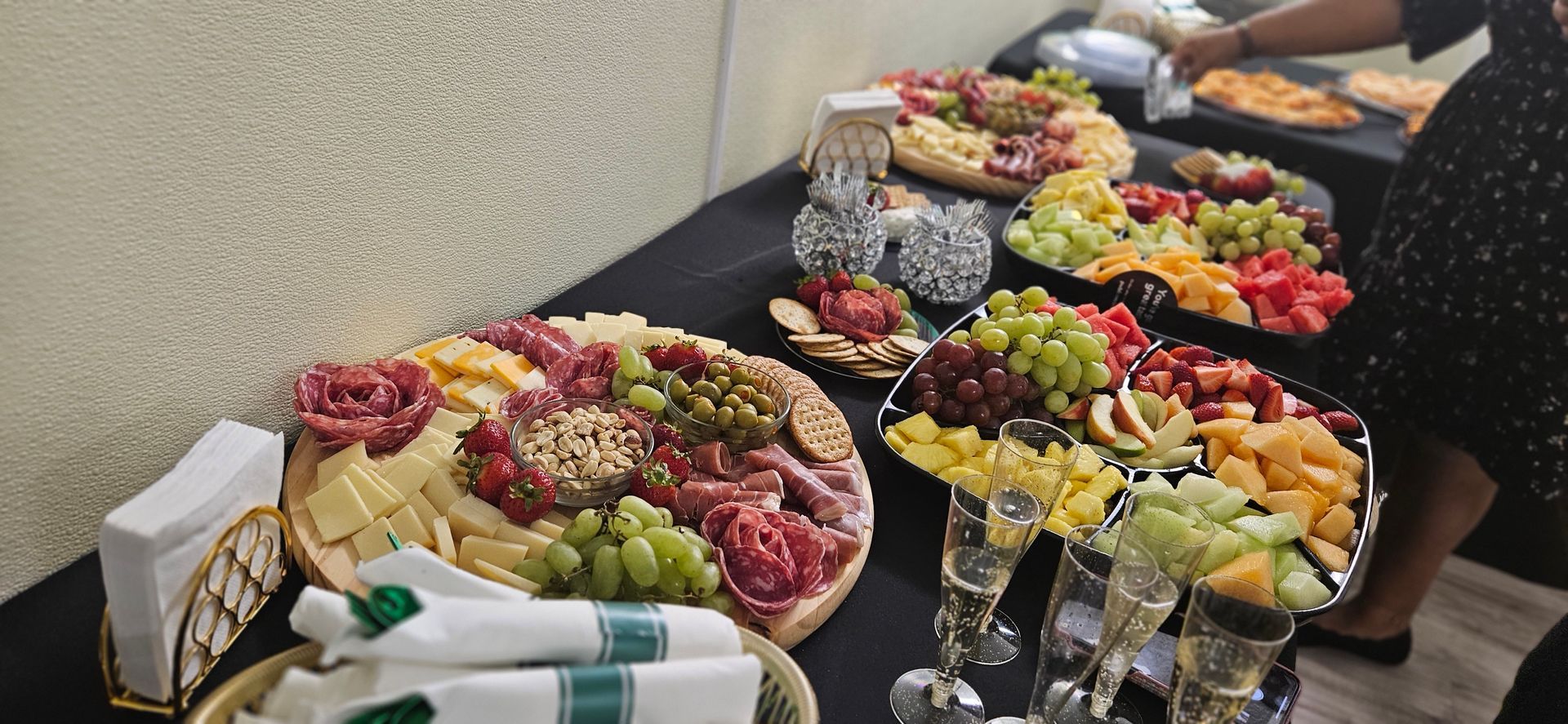 A table topped with plates of food and wine glasses.