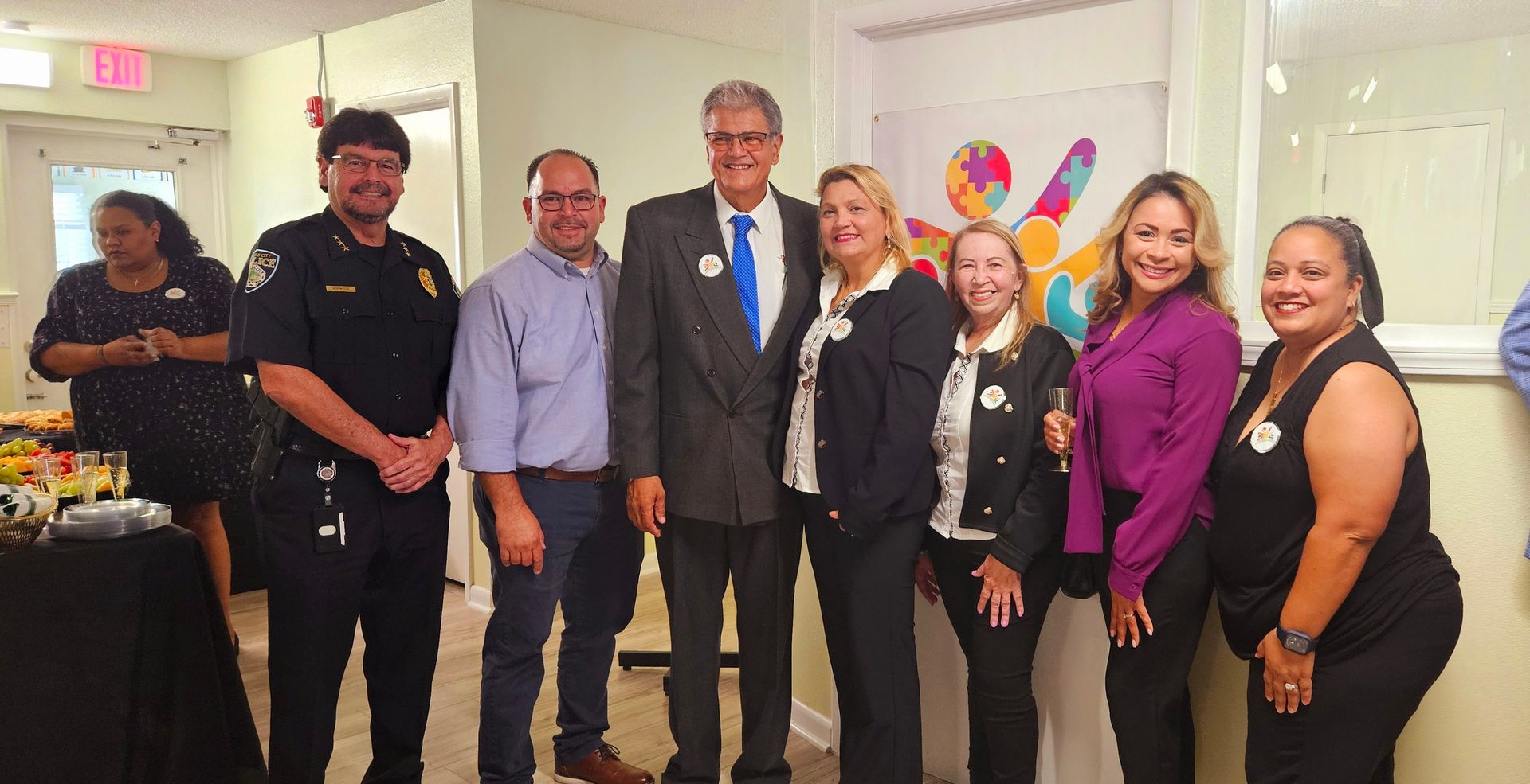 A group of people standing next to each other in a room.