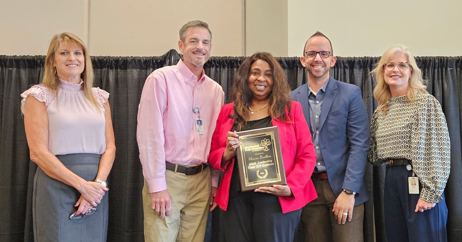 A group of people standing next to each other holding a certificate.