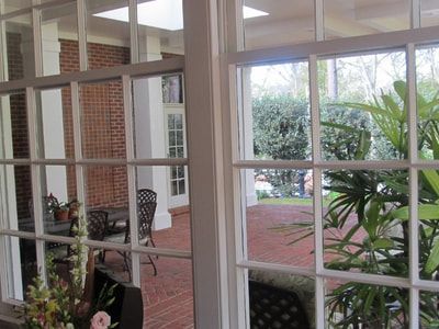 A view of a patio through a window of a house.