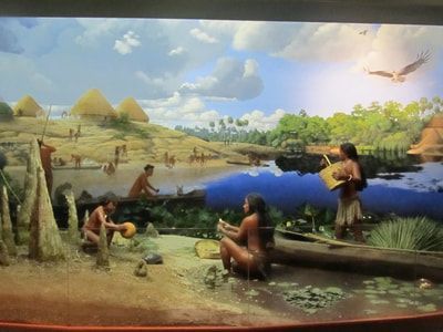 A painting of native americans in a canoe near a river