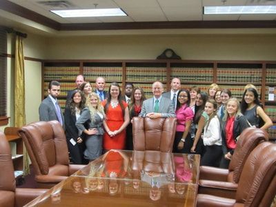 A group of people are posing for a picture in a conference room.