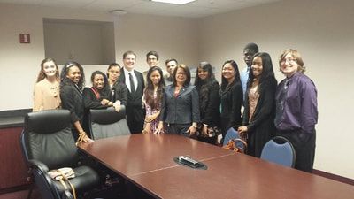 A group of people are posing for a picture in a conference room.