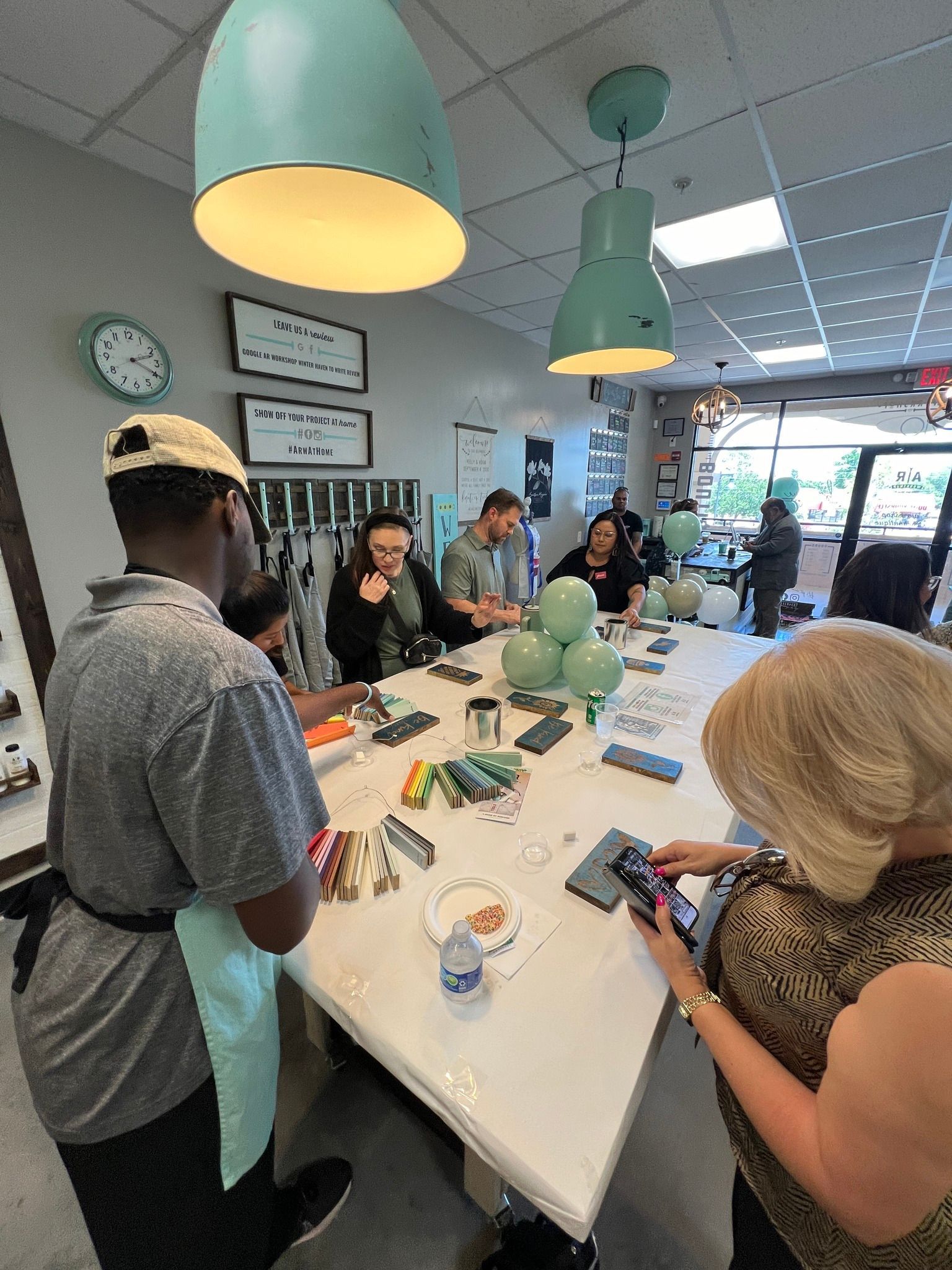 A group of people are sitting around a table in a room.