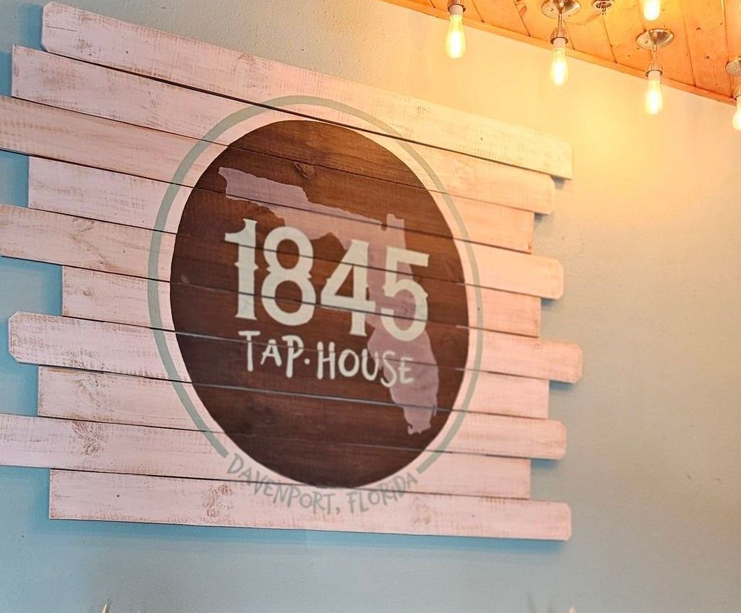 A sign on a wall that says 1845 tap house