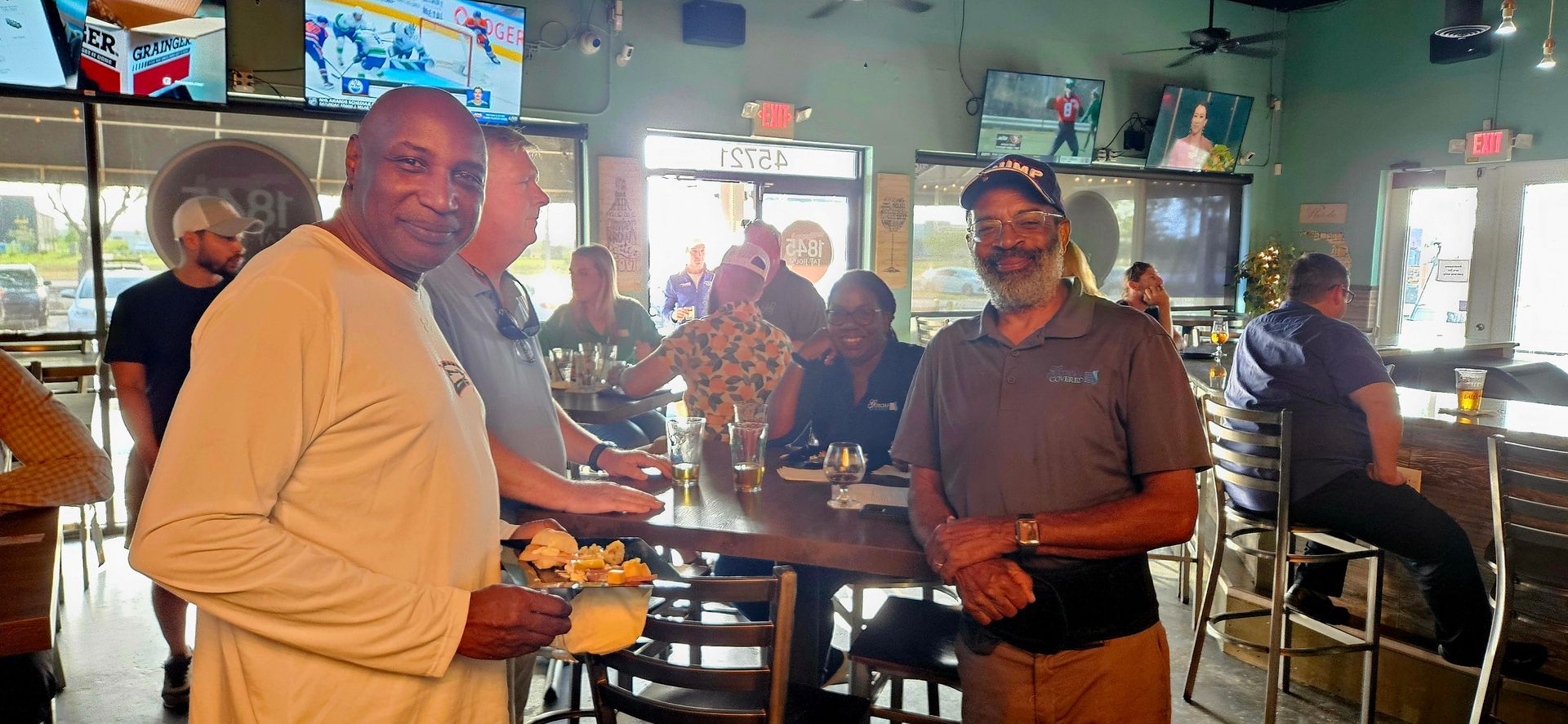 A group of men are standing in a restaurant.