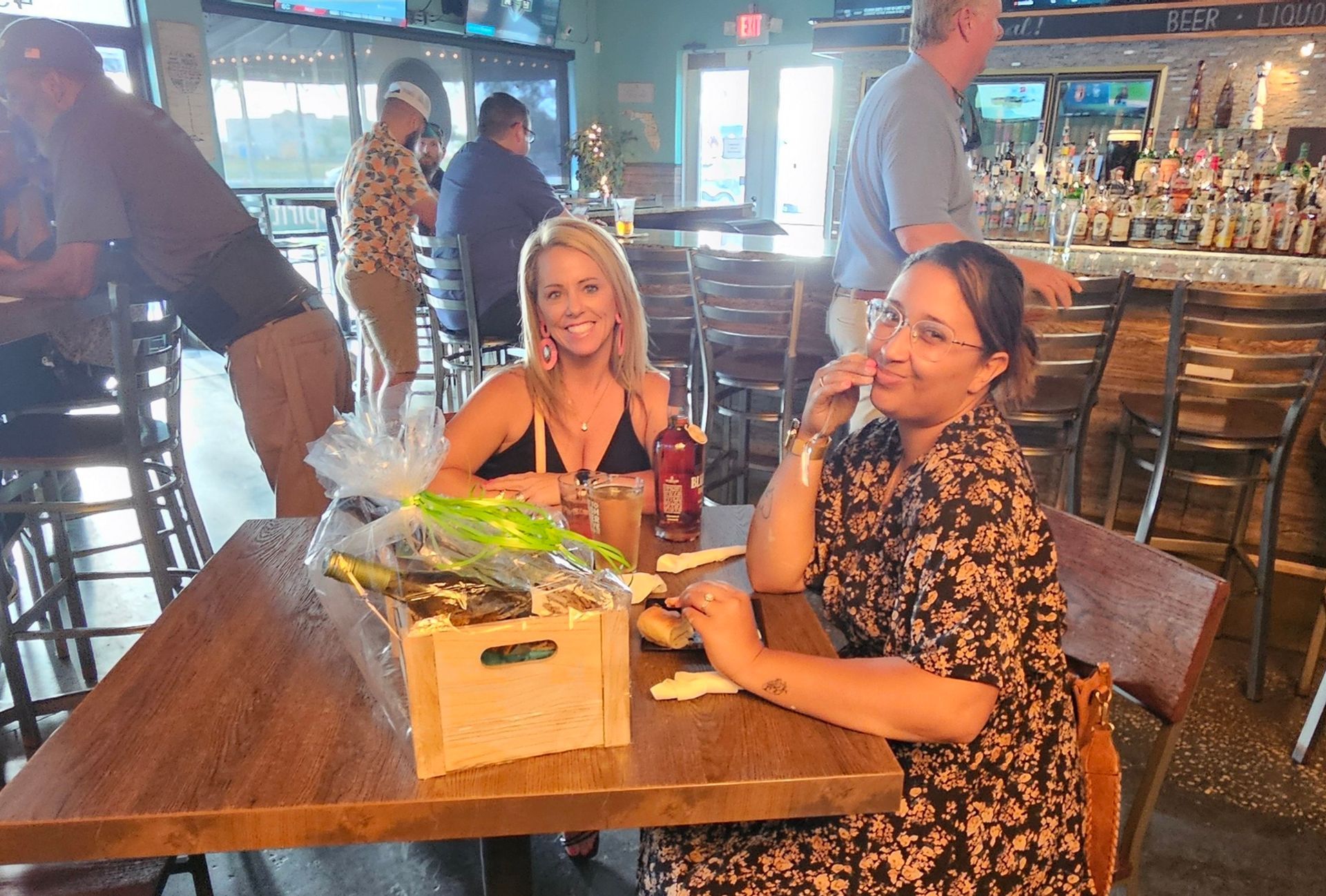 Two women are sitting at a table in a restaurant.