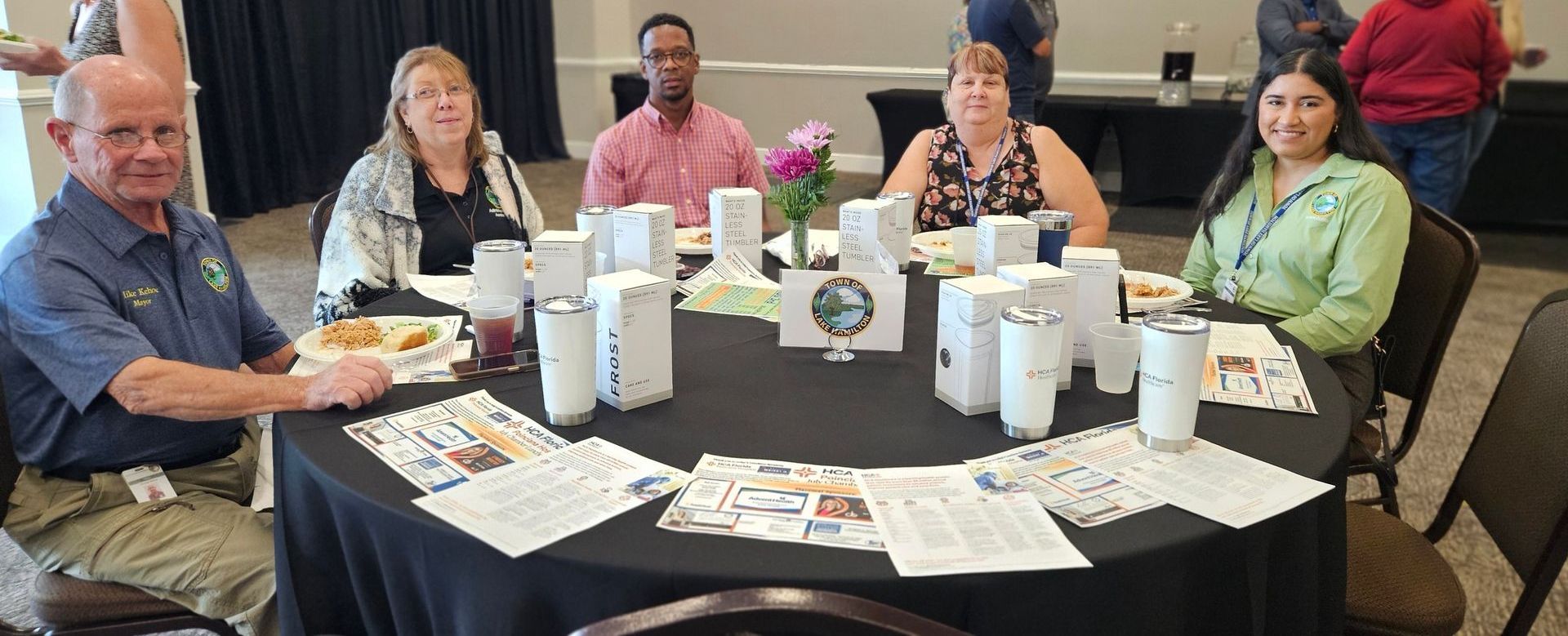 A group of people are sitting around a table.