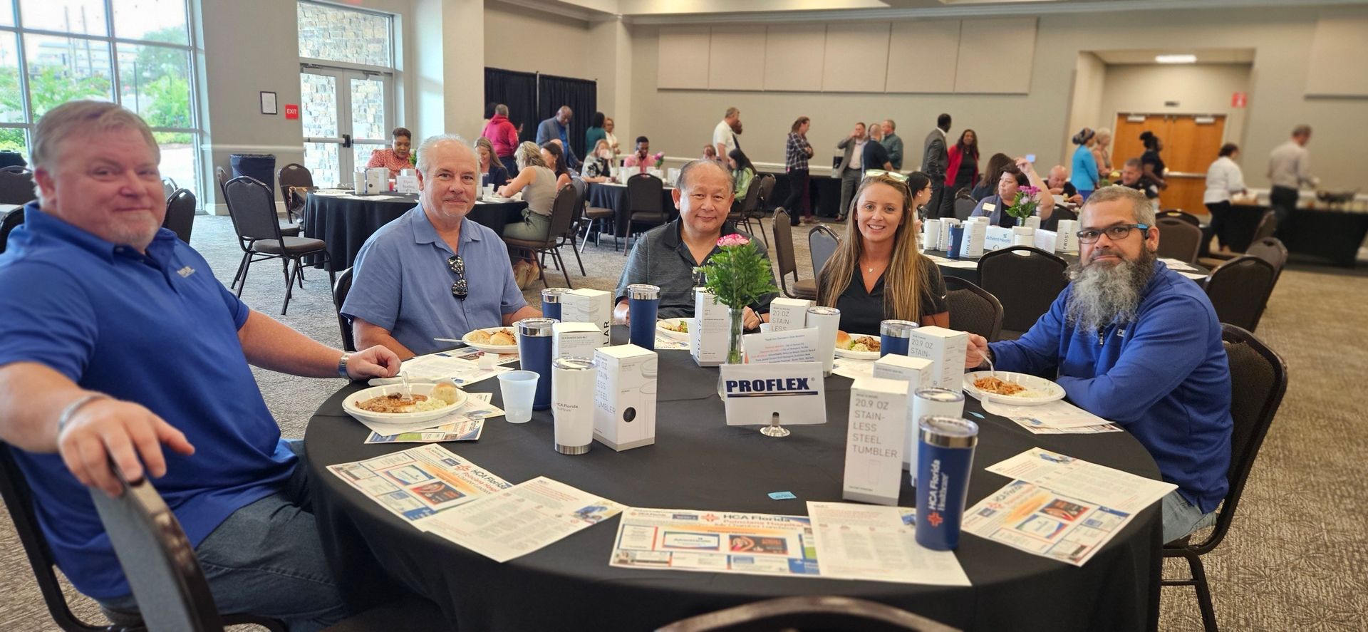 A group of people are sitting at a table in a room.