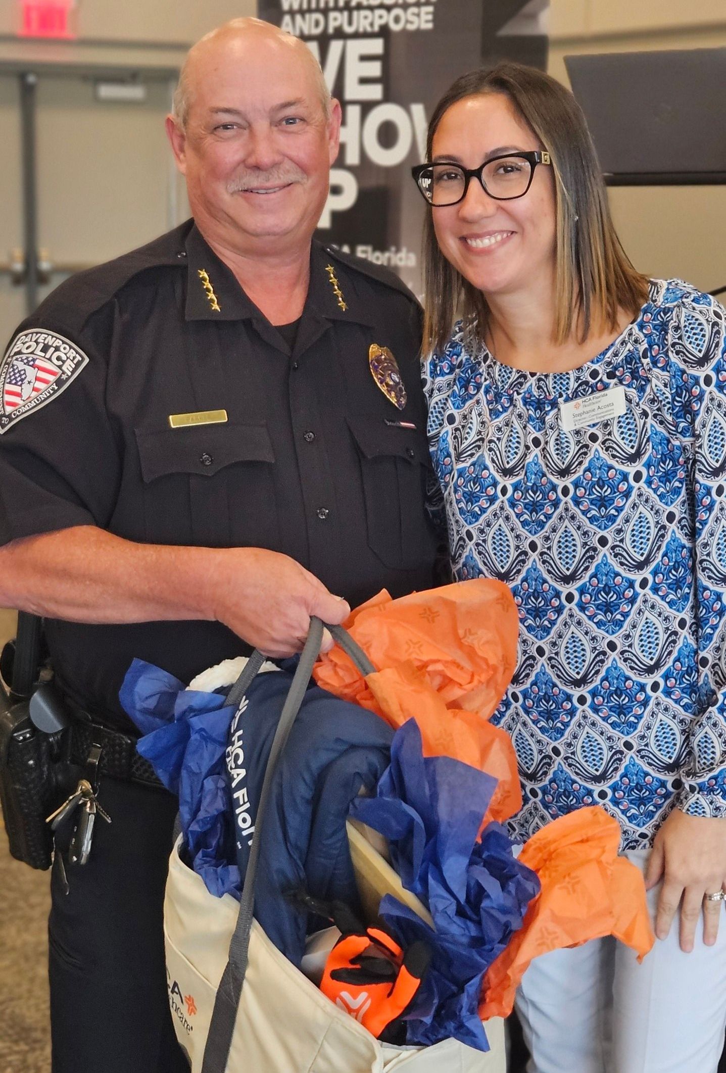 A police officer and a woman are posing for a picture