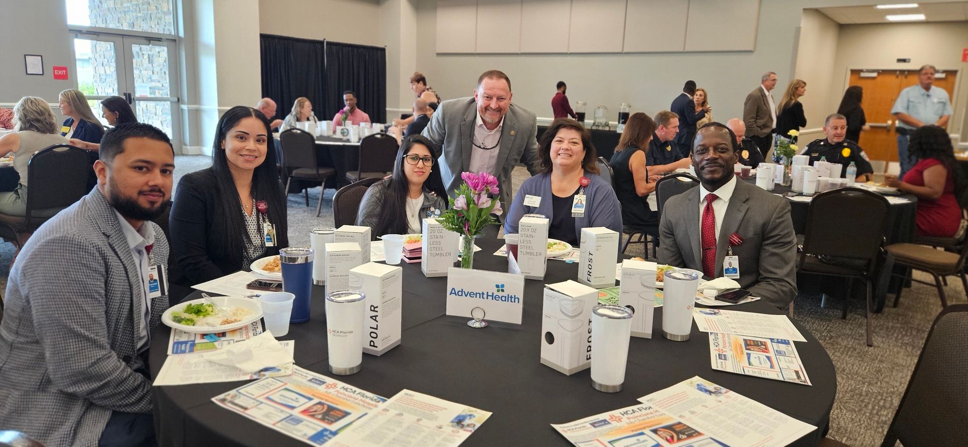 A group of people are sitting at a table in a room.