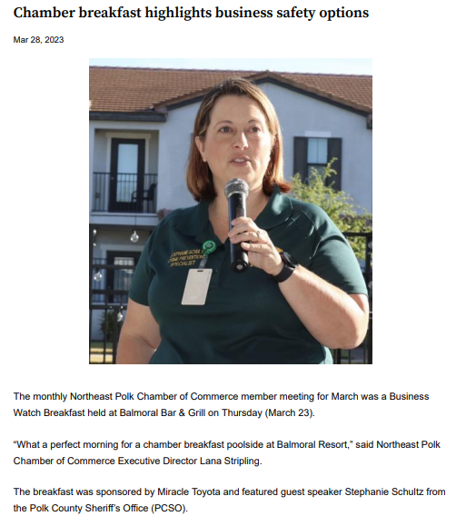 A woman is holding a microphone in front of a building.