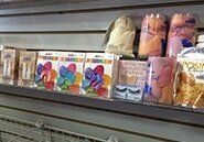 A shelf filled with lots of different types of balloons and decorations