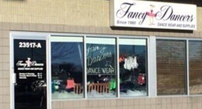 A building with a sign that says fancy dancers on it