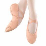 A pair of pink ballet shoes on a person 's feet