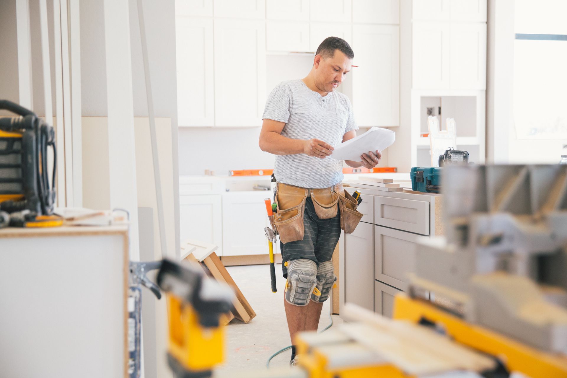 A contractor working on residential kitchen renovation services. A contractor working on residential kitchen renovation services.