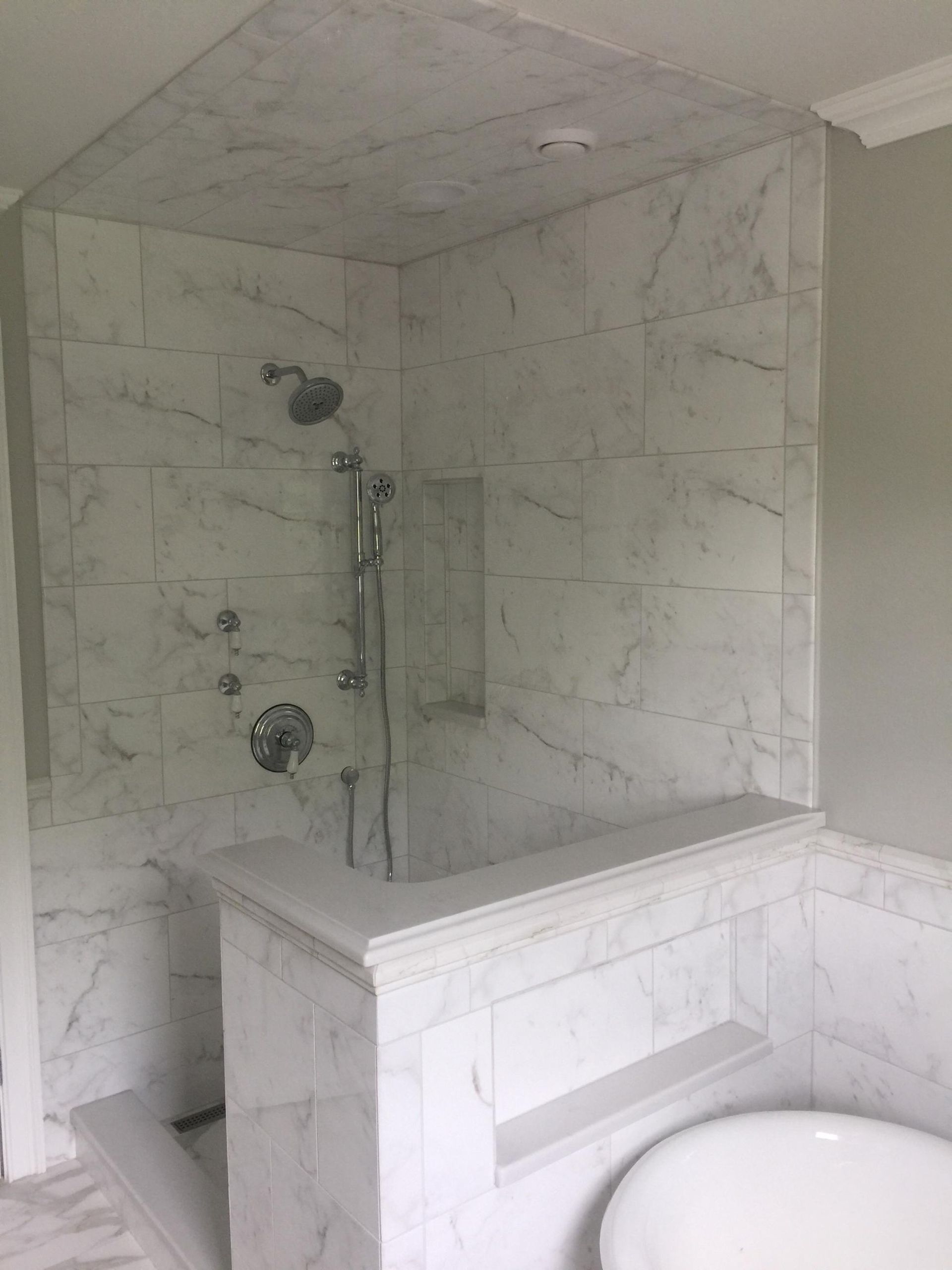 A bathroom with a walk in shower and a bathtub.