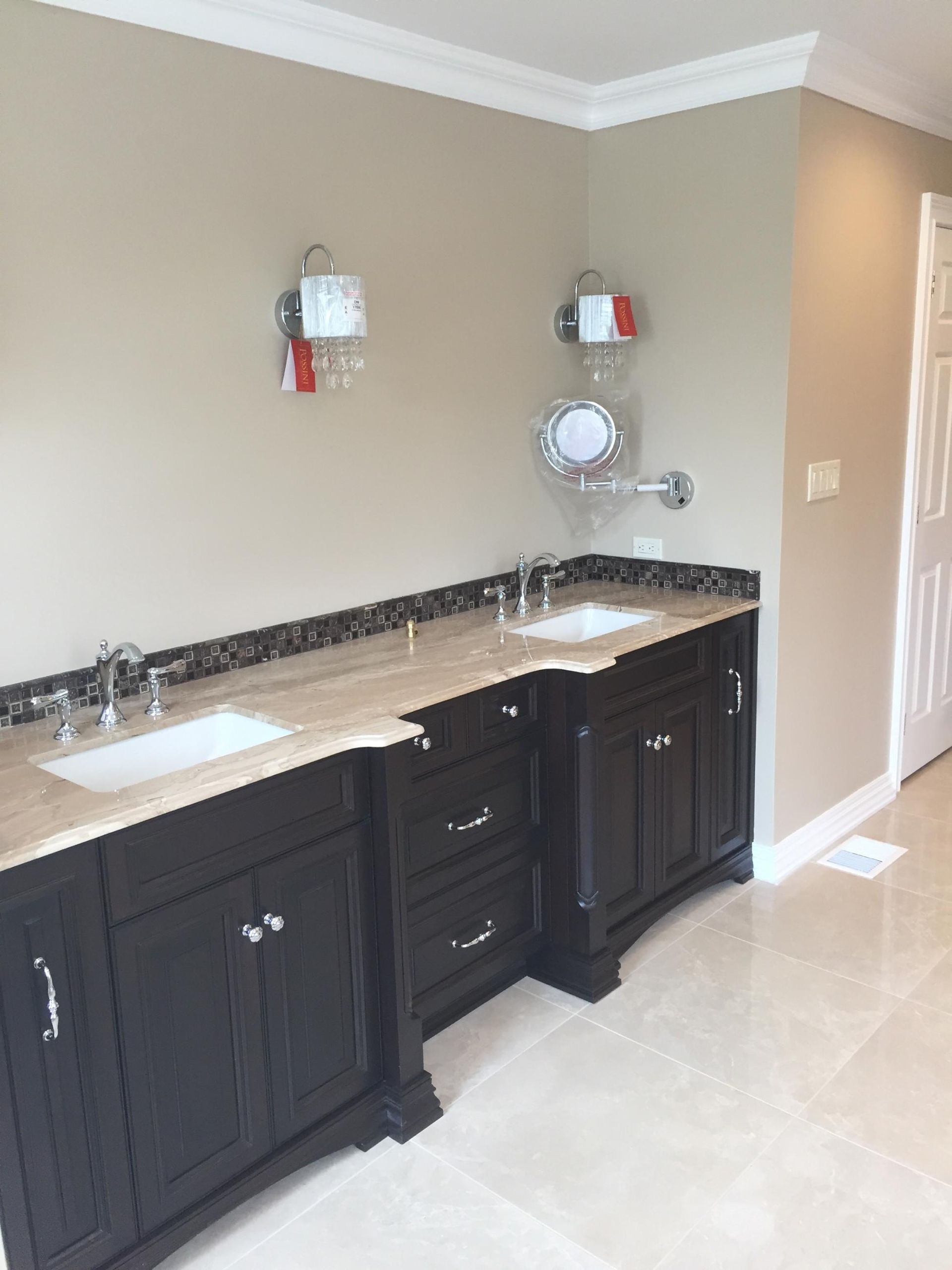 A bathroom with black cabinets and two sinks