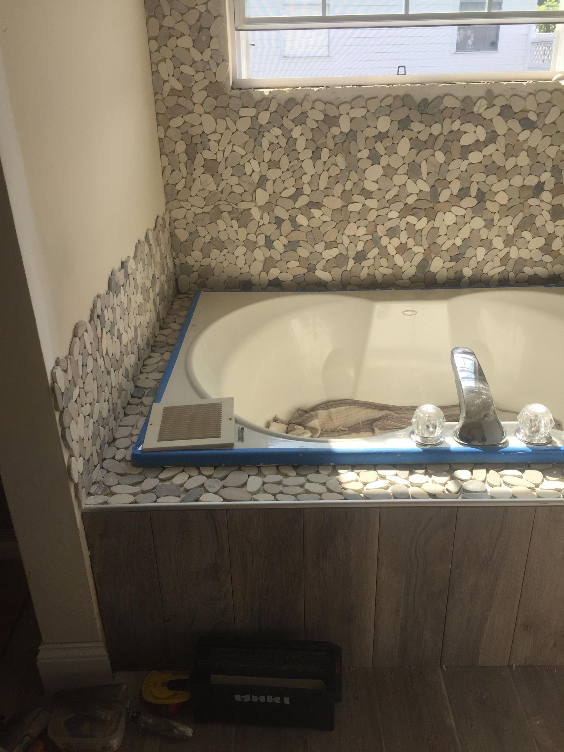 A bathtub is being remodeled in a bathroom.