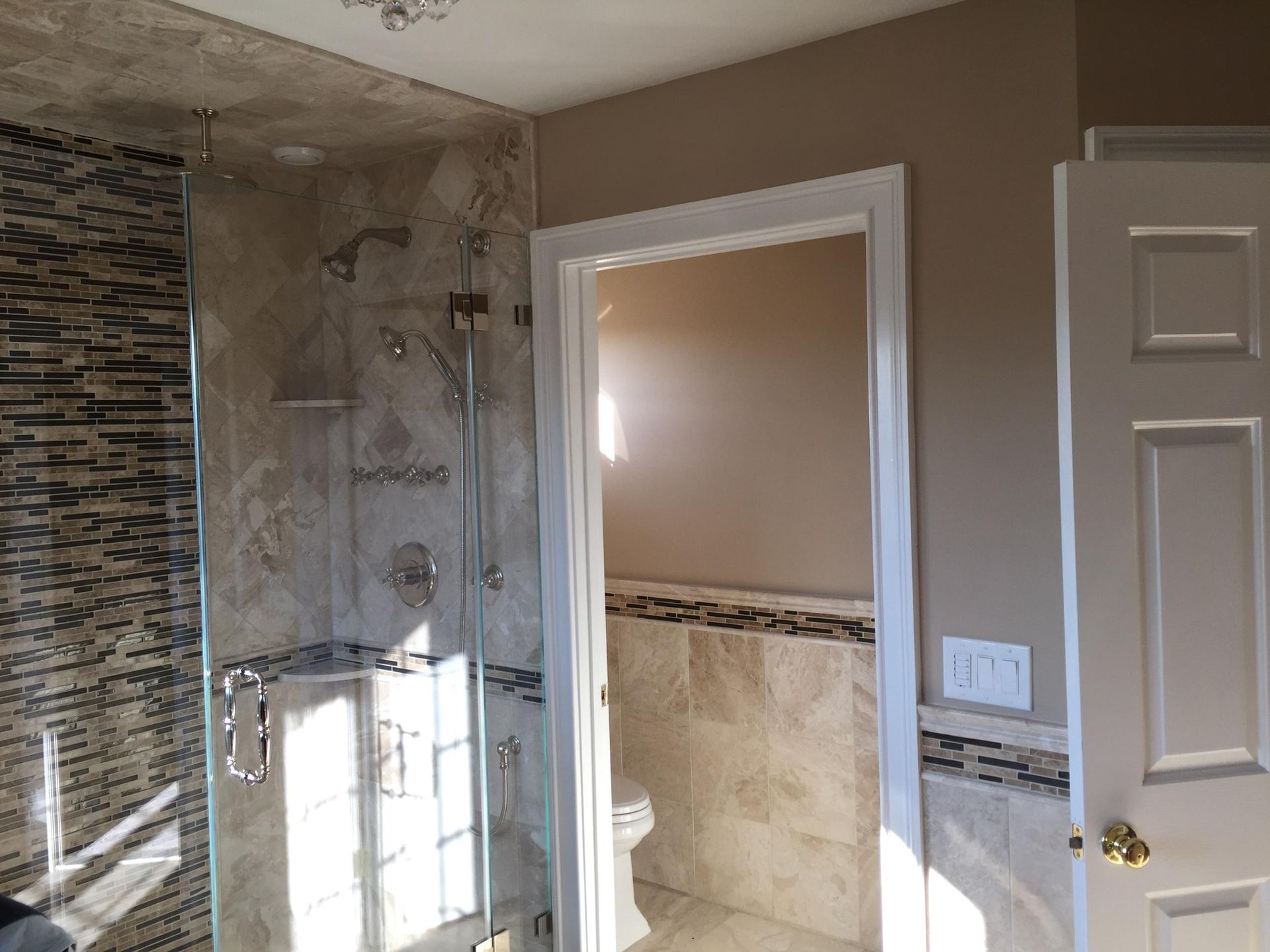 A bathroom with a walk in shower and a toilet.