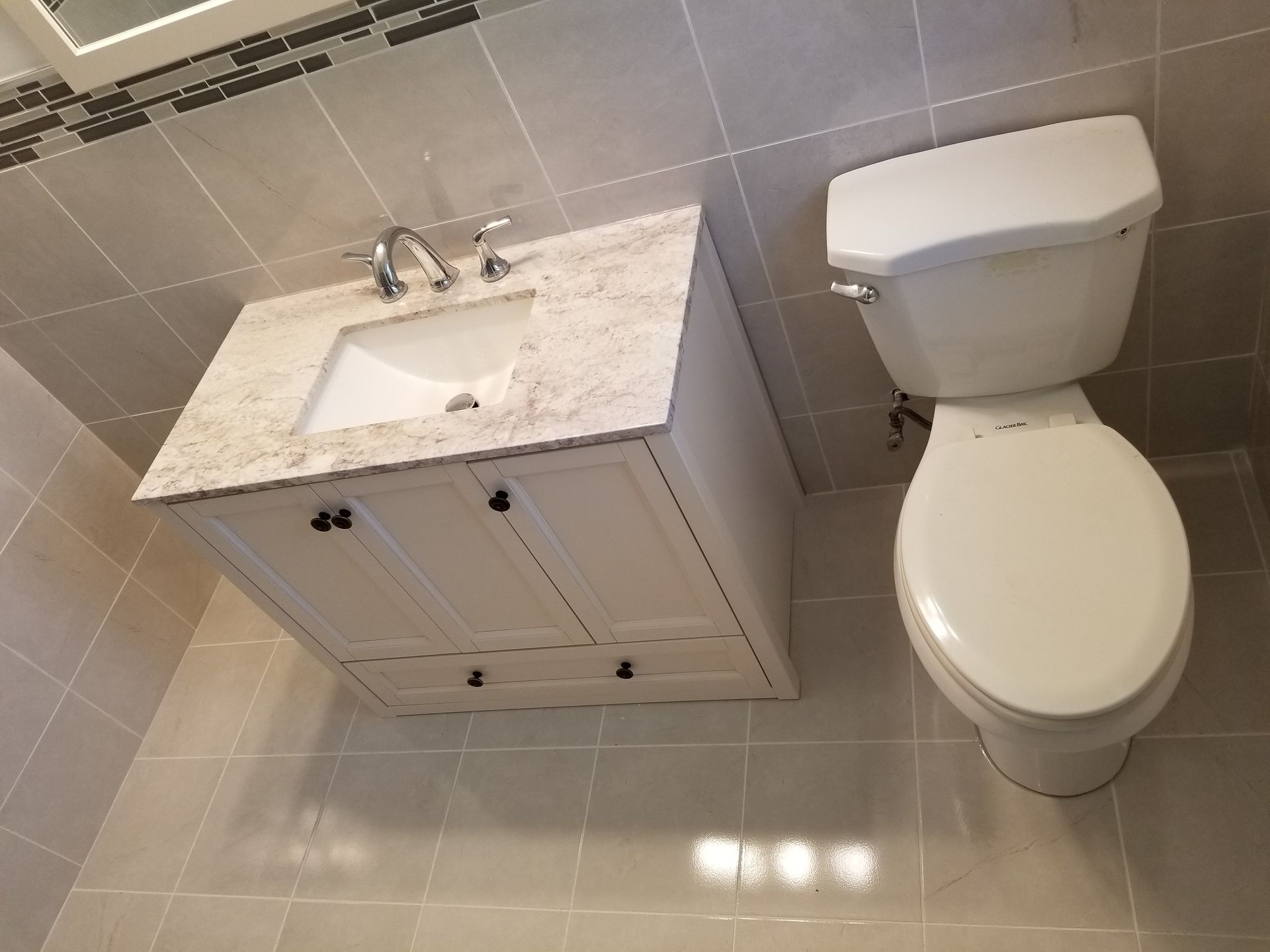 A bathroom with a sink and toilet in it