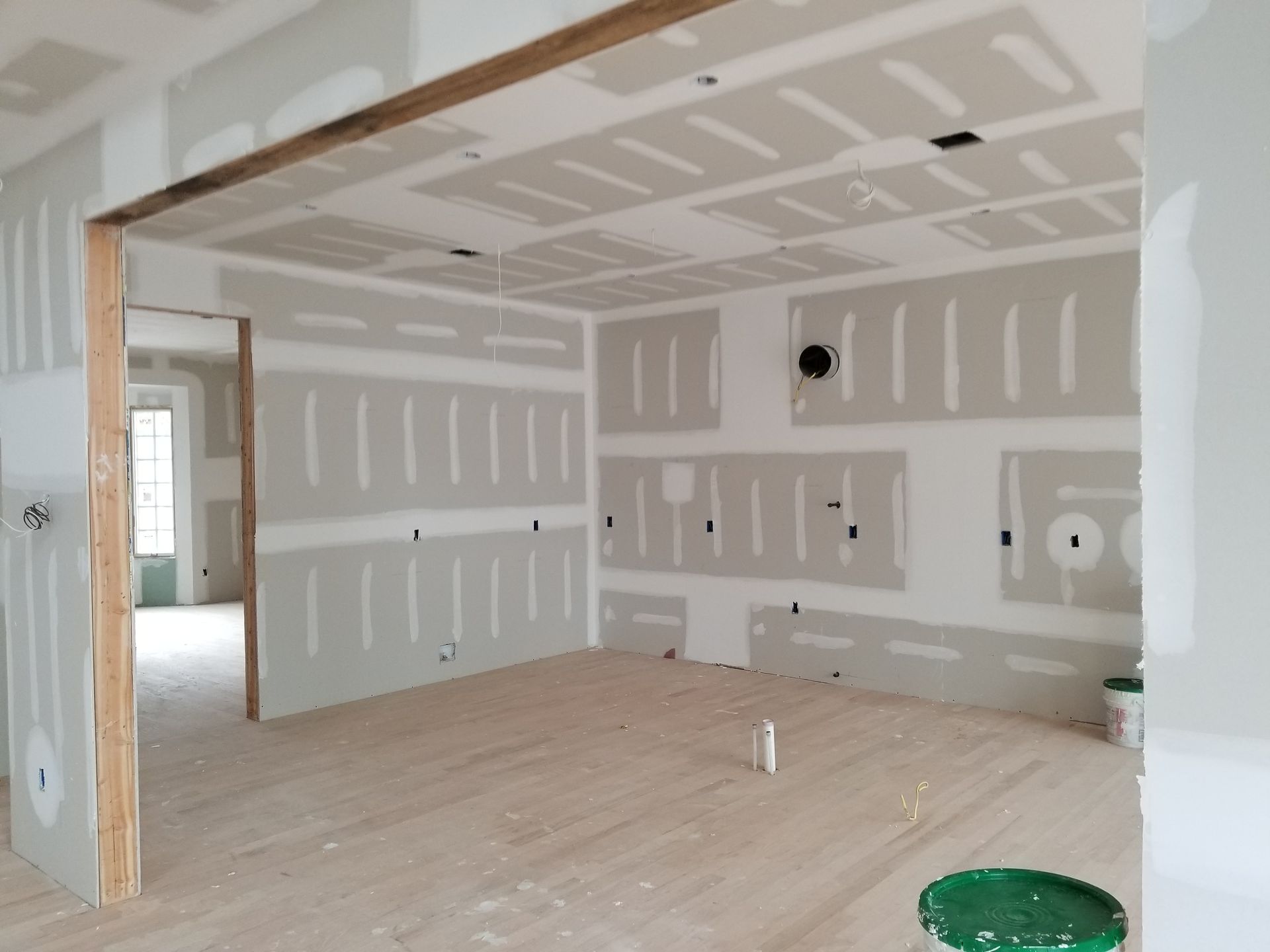 An empty room with drywall on the walls and ceiling