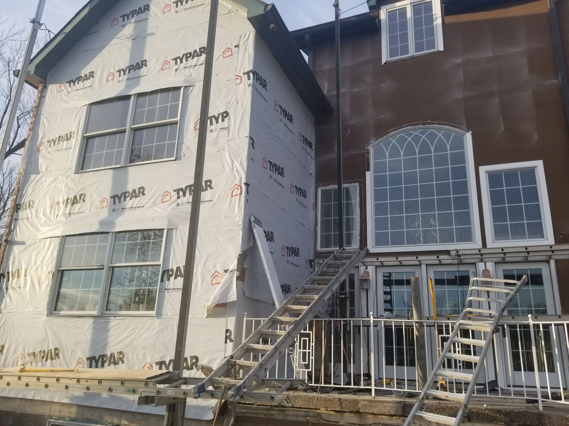 A house with stairs leading up to it is being remodeled.