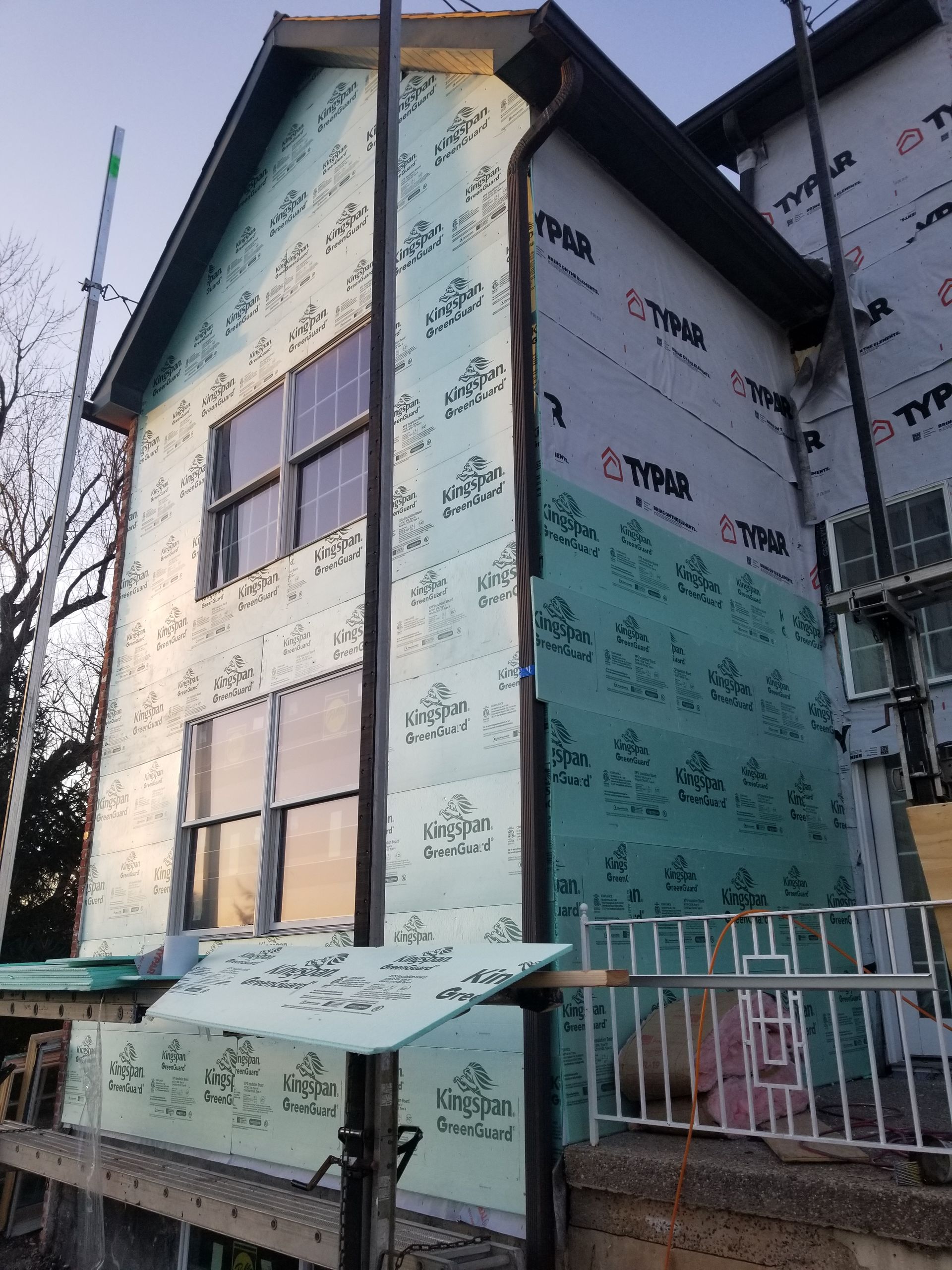 A house with a lot of windows is being remodeled
