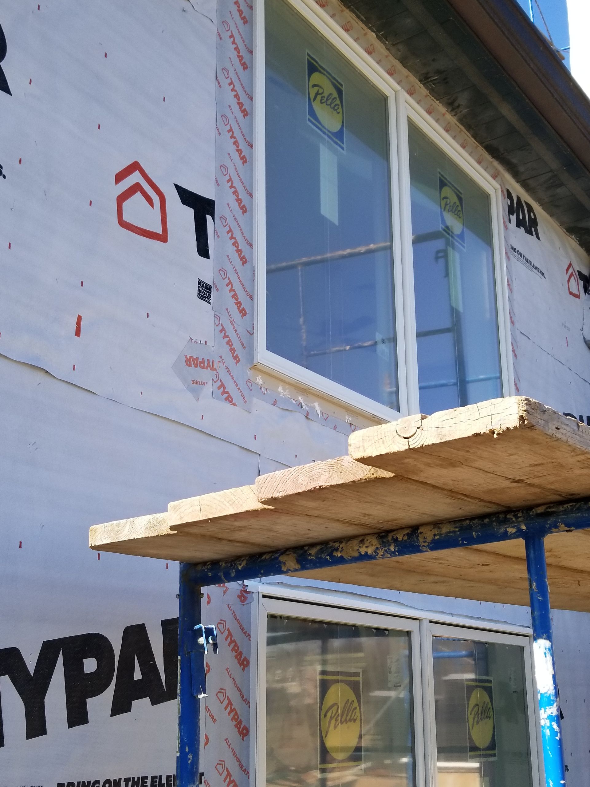 A window is being installed on the side of a building
