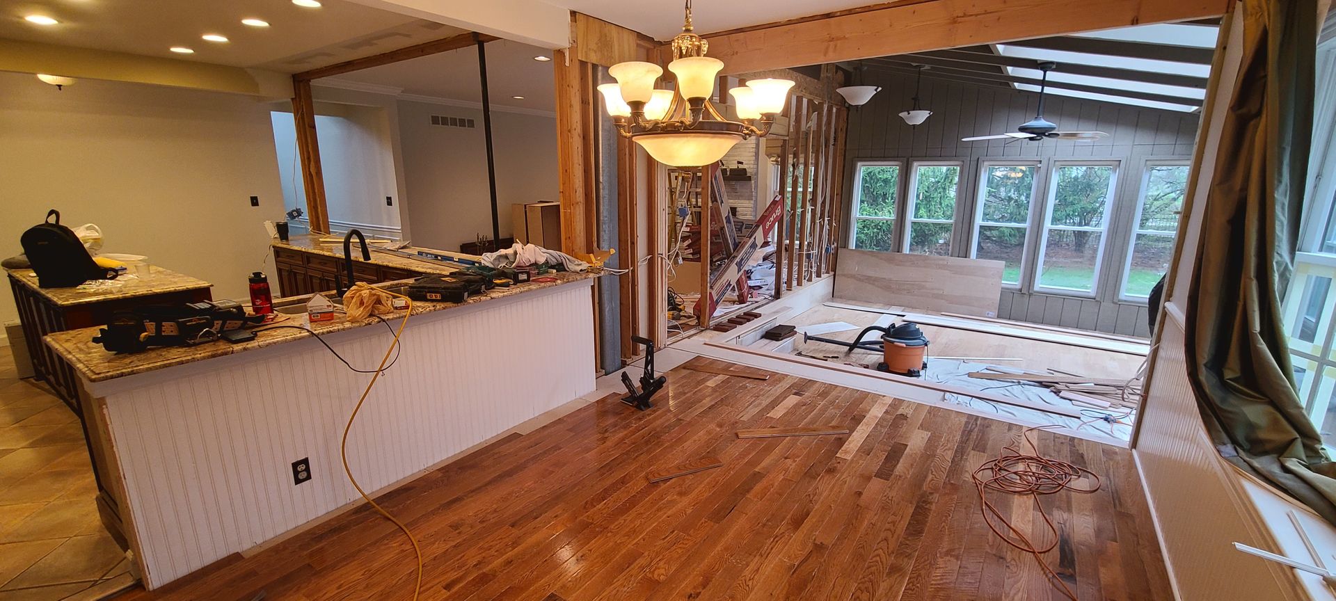 A kitchen and dining room are being remodeled in a house.