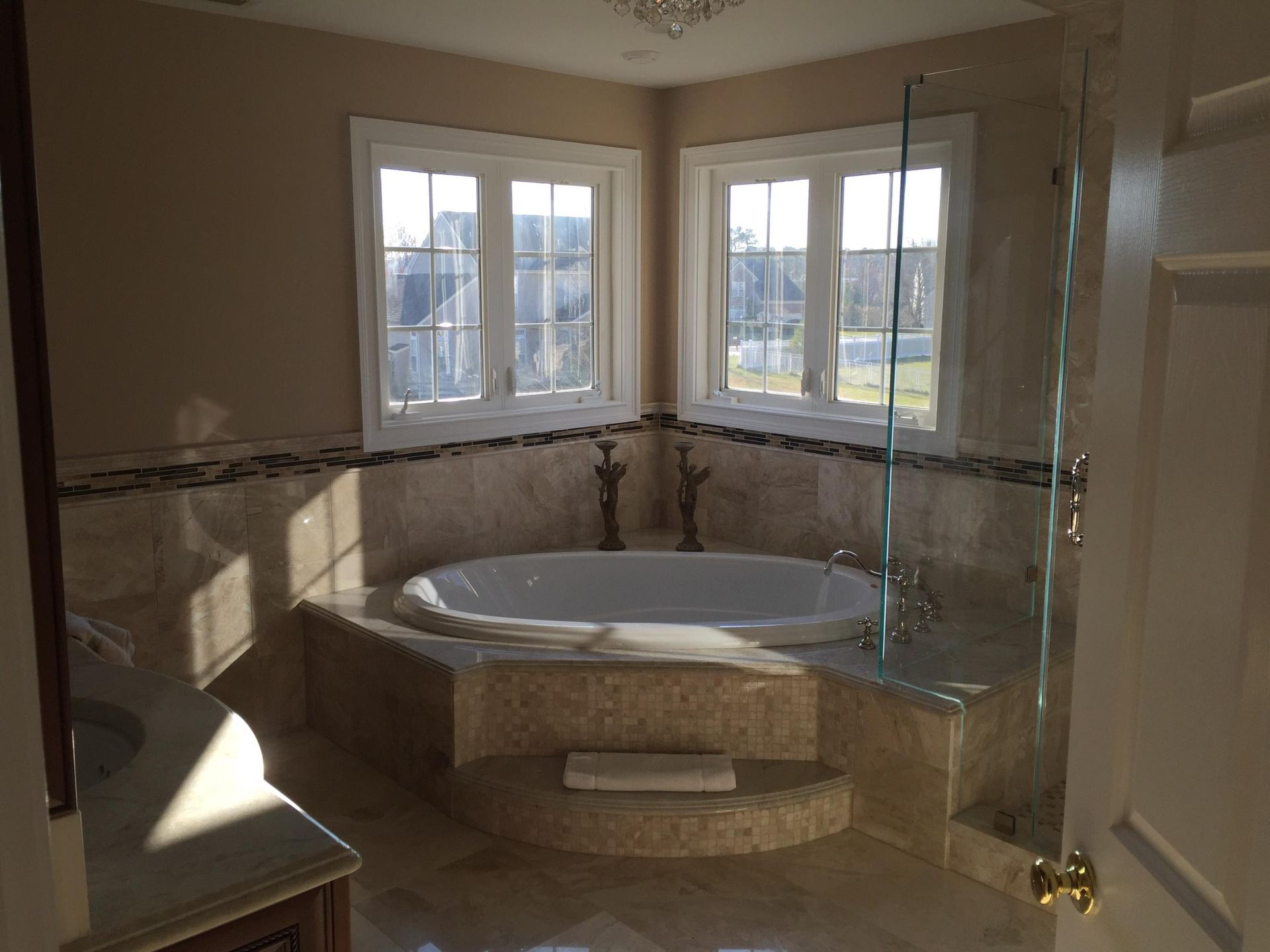 A bathroom with a tub , sink , and shower.