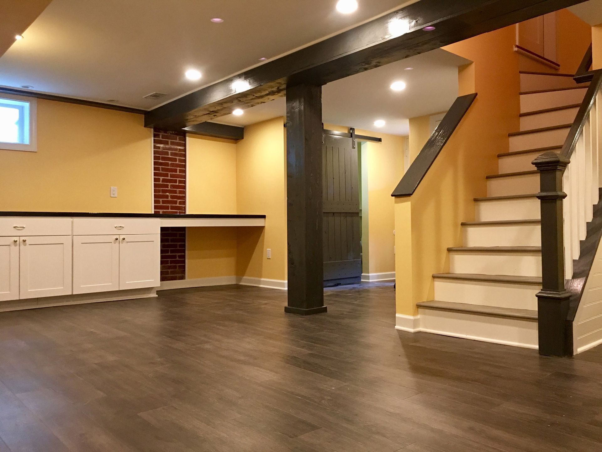 An empty basement with stairs leading up to the second floor