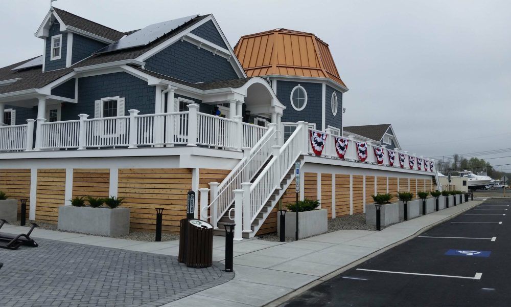 A blue and white house with stairs leading up to it.