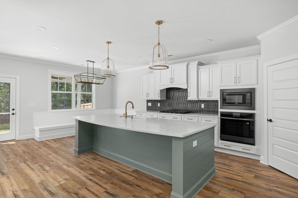There is a large island in the middle of the kitchen.