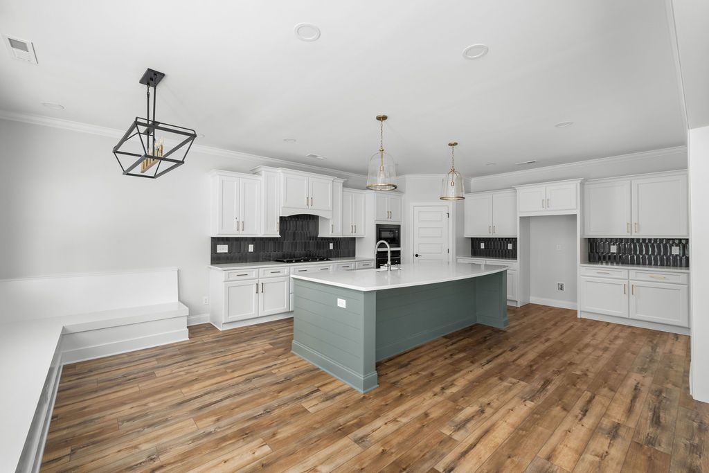 There is a large island in the middle of the kitchen.