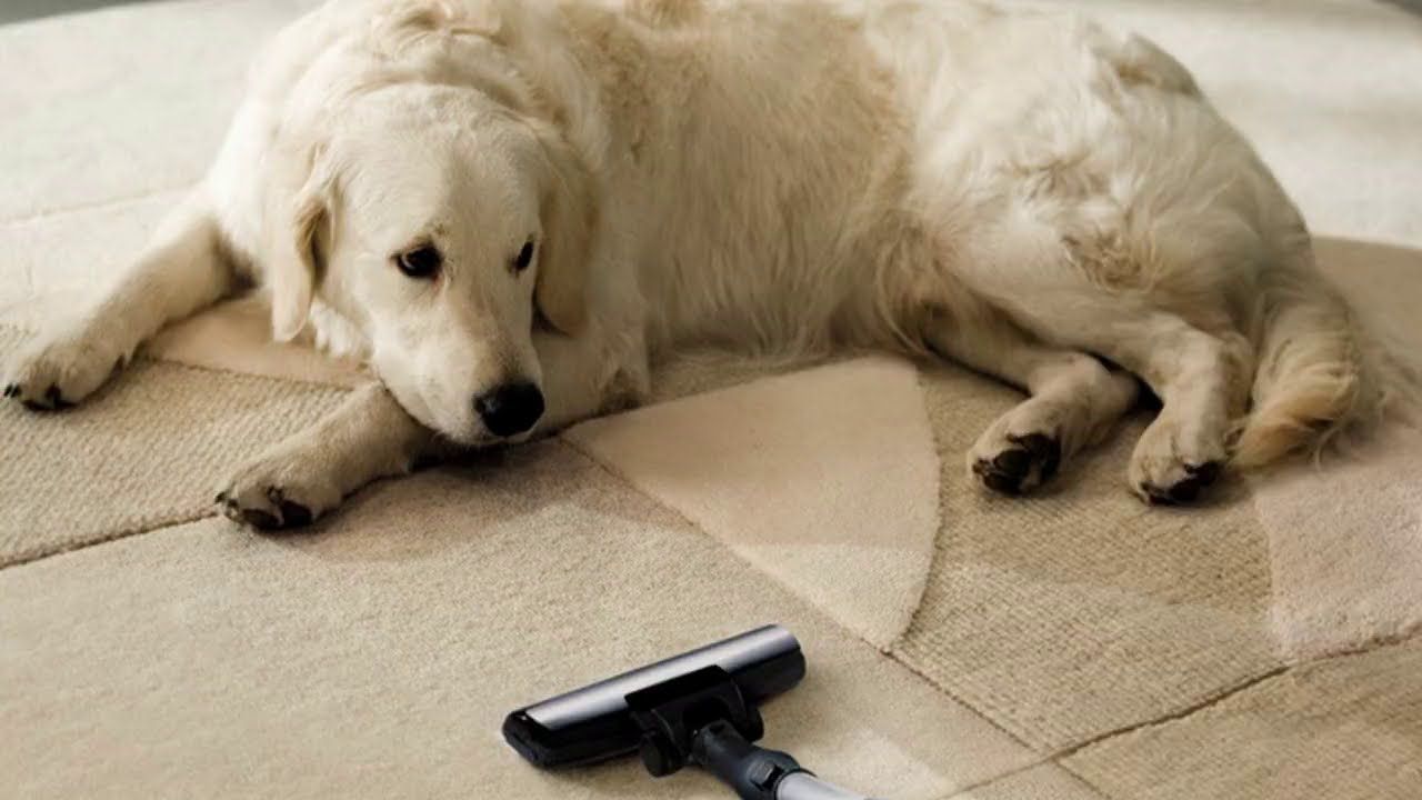 A man is sitting on the floor fixing an air conditioner.